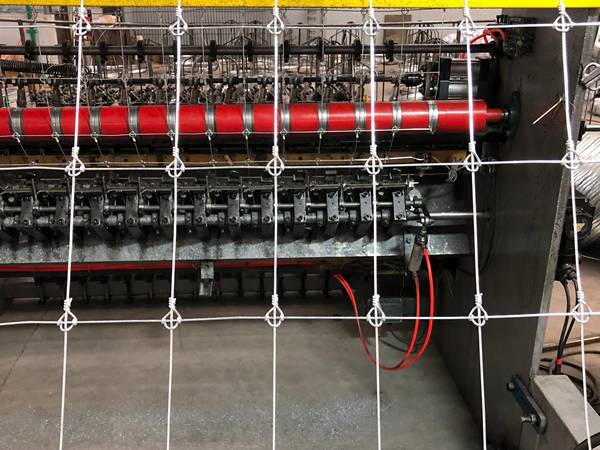 A working machine is producing fixed knot fence.