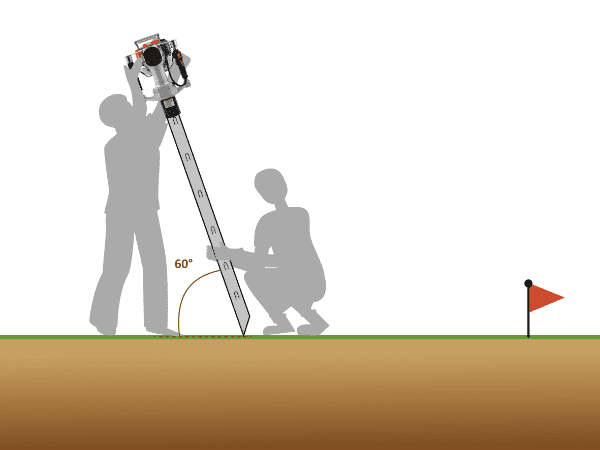 A worker is driving vineyard end post into ground.